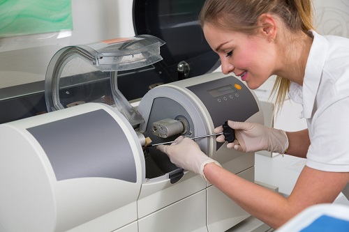 Dentist's assisstant operating CEREC Milling machine